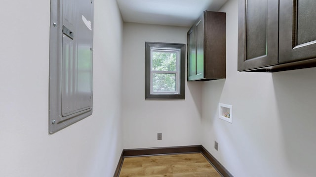 2038 Ogburn Chapel Rd, Clarksville, TN 37042 - laundry room with cabinet space, washer hookup, wood finished floors, and baseboards