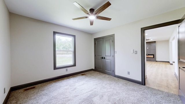 2038 Ogburn Chapel Rd, Clarksville, TN 37042 - unfurnished bedroom featuring light carpet, baseboards, a closet, and a ceiling fan