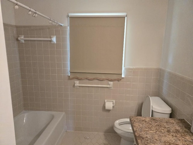 1309 Jackson Dr, Pulaski, TN 38478 - full bath featuring toilet, tile walls, tile patterned flooring, wainscoting, and washtub / shower combination