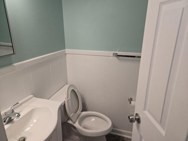 1309 Jackson Dr, Pulaski, TN 38478 - bathroom featuring a sink, toilet, and a wainscoted wall