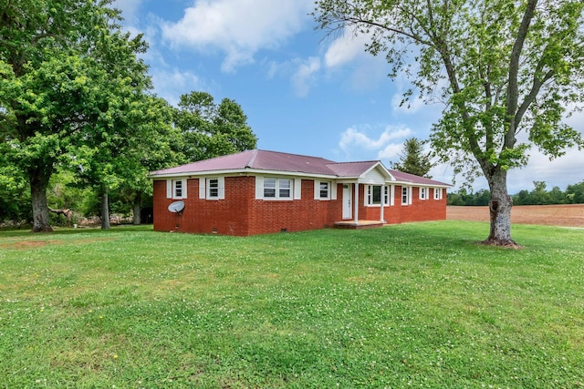 single story home with a front lawn, brick siding, metal roof, and crawl space