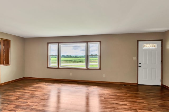 foyer entrance featuring wood finished floors and baseboards