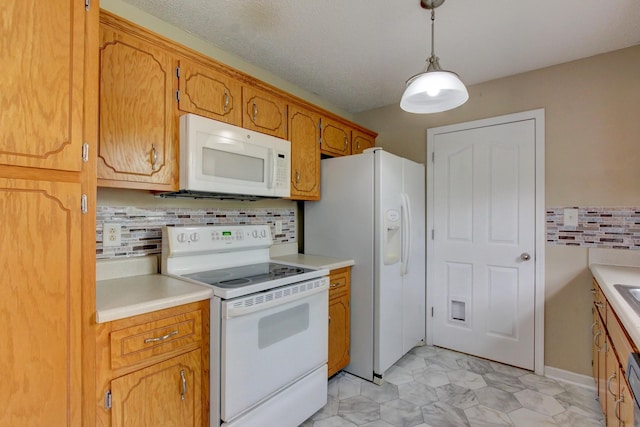 kitchen featuring white appliances, light countertops, and decorative backsplash