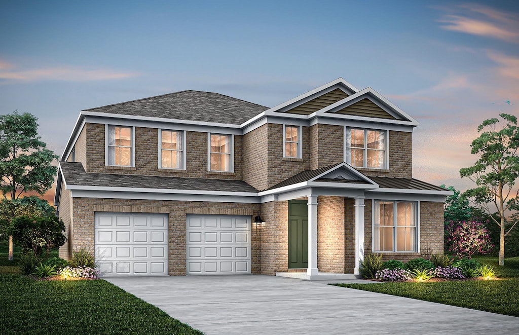 view of front of home with a garage, driveway, and brick siding
