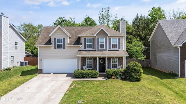 516 Trainmaster Dr, Maryville, TN 37804 - traditional home with driveway, a chimney, cooling unit, a porch, and brick siding