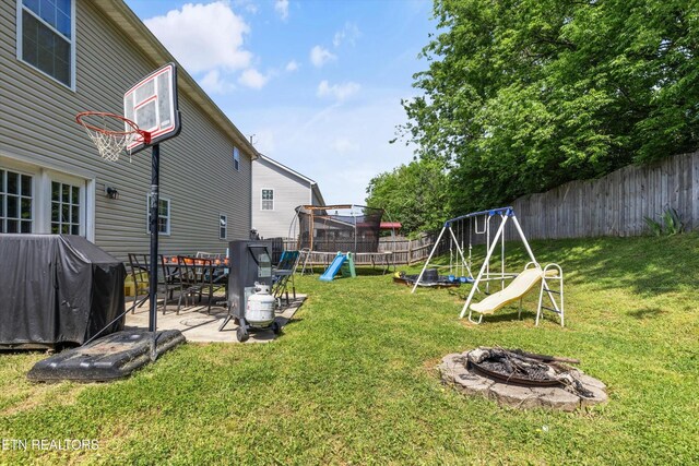 516 Trainmaster Dr, Maryville, TN 37804 - view of yard featuring a playground, an outdoor fire pit, and a patio