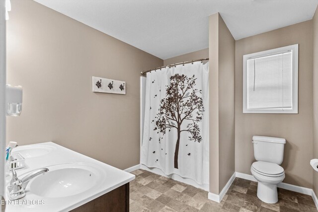 516 Trainmaster Dr, Maryville, TN 37804 - bathroom with baseboards, toilet, curtained shower, and double vanity