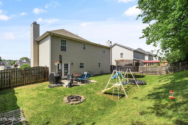 516 Trainmaster Dr, Maryville, TN 37804 - back of house featuring a fire pit, a chimney, a patio, and a playground
