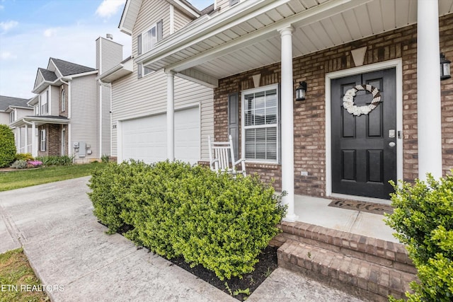 516 Trainmaster Dr, Maryville, TN 37804 - property entrance featuring brick siding, a garage, and covered porch