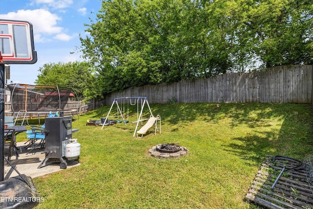 516 Trainmaster Dr, Maryville, TN 37804 - view of yard featuring a trampoline, a fire pit, a playground, and a patio area