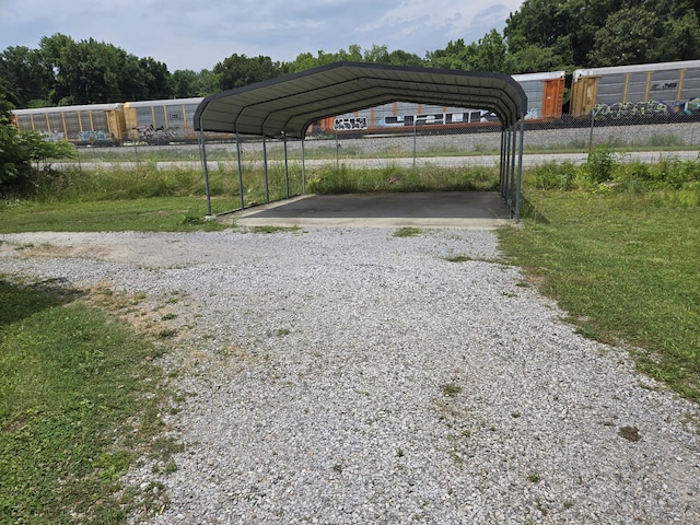 307 E Commerce St, Waverly, TN 37185 - view of car parking with gravel driveway and a detached carport