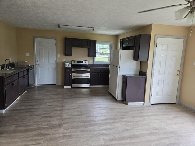 307 E Commerce St, Waverly, TN 37185 - kitchen featuring stainless steel appliances, a sink, a textured ceiling, ceiling fan, and light wood-style floors