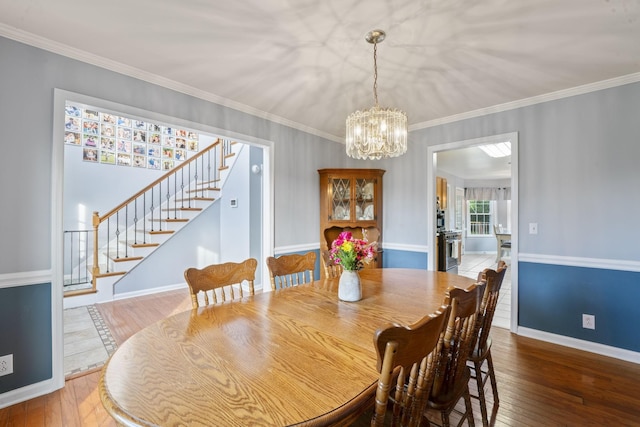 3630 W Trimble Rd, Milton, TN 37118 - dining space with stairs, hardwood / wood-style flooring, a chandelier, crown molding, and baseboards
