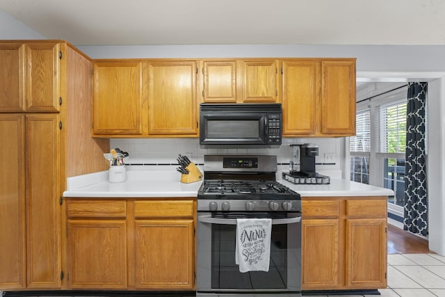 3630 W Trimble Rd, Milton, TN 37118 - kitchen with black microwave, stainless steel range with gas cooktop, light countertops, and light tile patterned floors