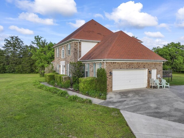 3630 W Trimble Rd, Milton, TN 37118 - view of side of property featuring brick siding, asphalt driveway, a yard, and a garage