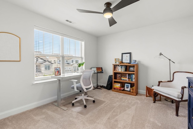 home office with carpet floors, ceiling fan, and baseboards