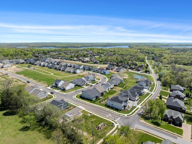 aerial view of property's location with a large body of water and nearby suburban area