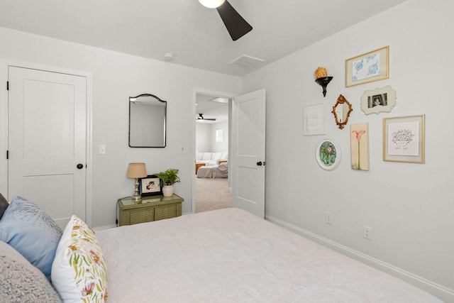 carpeted bedroom with baseboards and a ceiling fan
