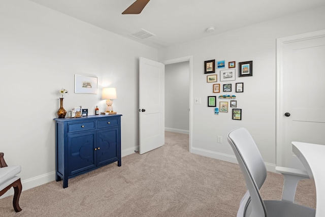office area with light colored carpet, ceiling fan, and baseboards