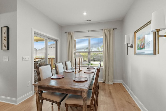 dining space featuring light wood finished floors, baseboards, and recessed lighting
