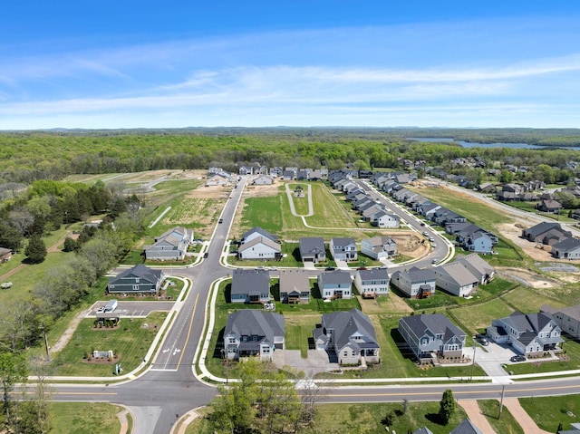 aerial overview of property's location with a forest and nearby suburban area