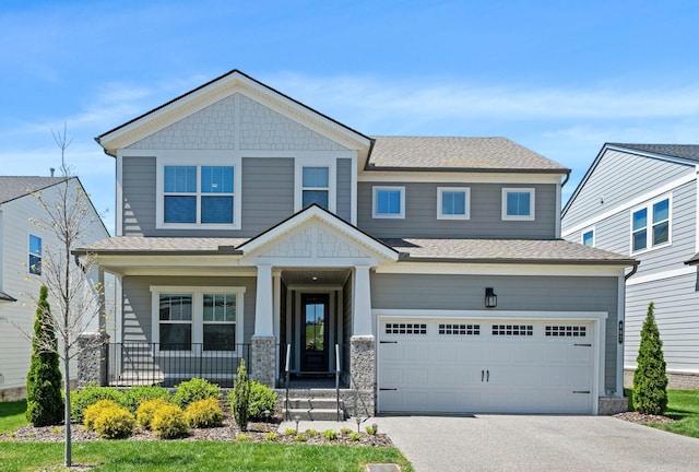 view of front of home featuring an attached garage, a porch, asphalt driveway, and a shingled roof