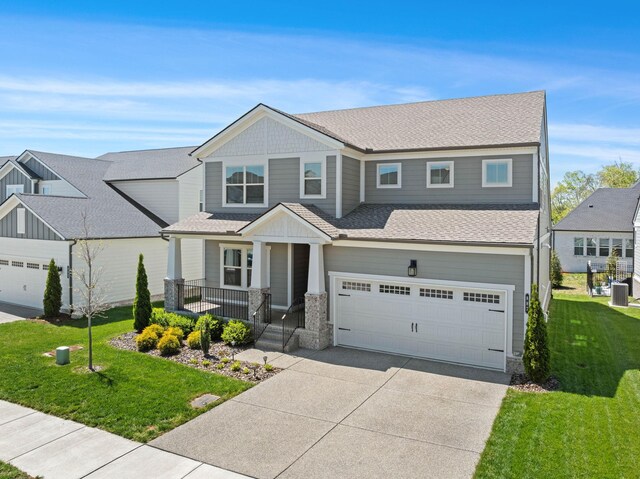 view of front of house with concrete driveway, a porch, an attached garage, a front yard, and central air condition unit