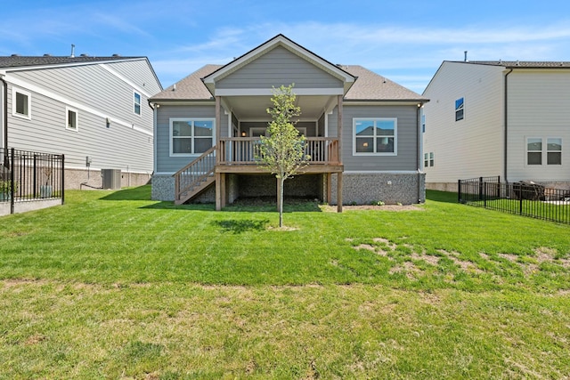 back of property with cooling unit, stairway, a deck, and roof with shingles