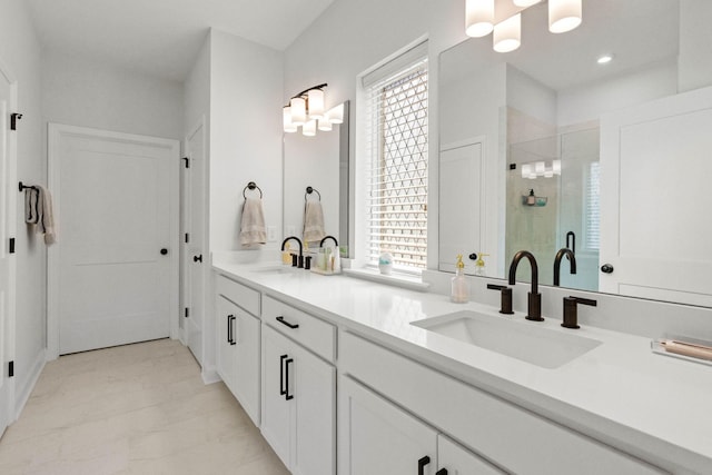 full bath with a shower stall, double vanity, a chandelier, recessed lighting, and marble finish flooring