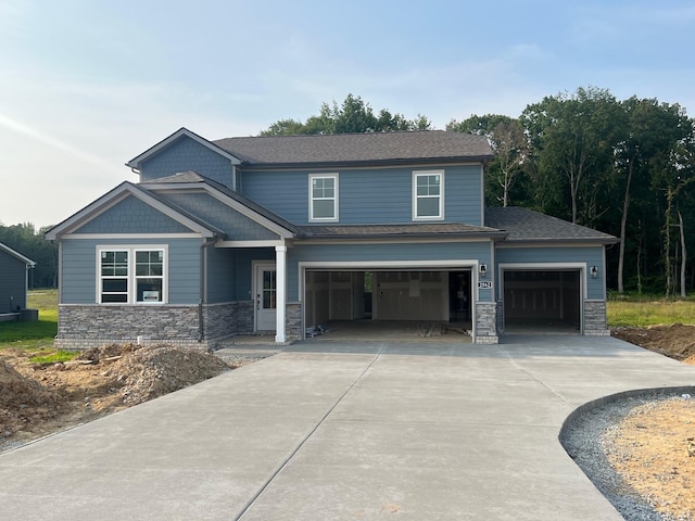 2562 Beverly Gail Rd, Pleasant View, TN 37146 - view of front of house with stone siding, concrete driveway, and an attached garage