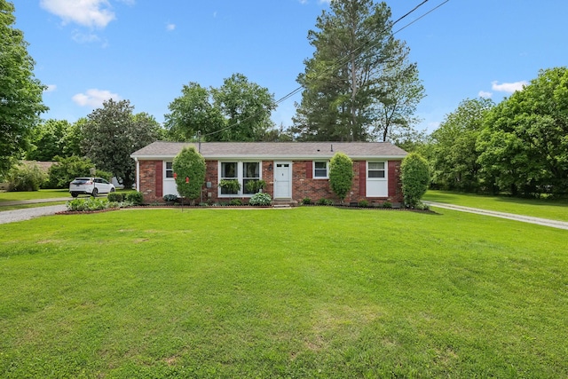 ranch-style house featuring brick siding and a front yard