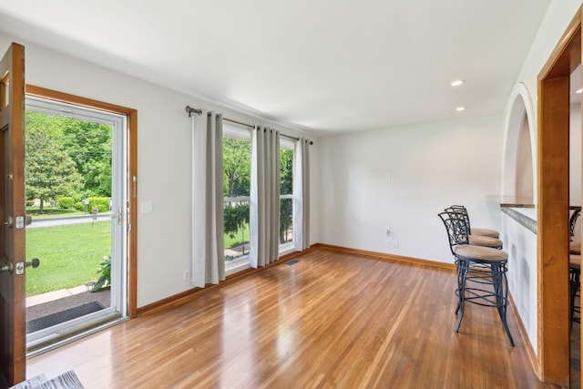 unfurnished living room featuring light wood-type flooring, baseboards, and recessed lighting