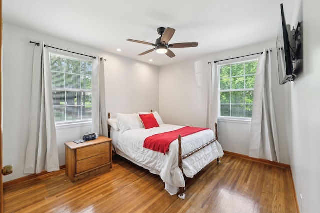 bedroom with wood finished floors, ceiling fan, baseboards, and recessed lighting
