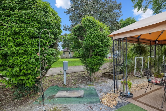 view of grassy yard with a gazebo and a wooden deck