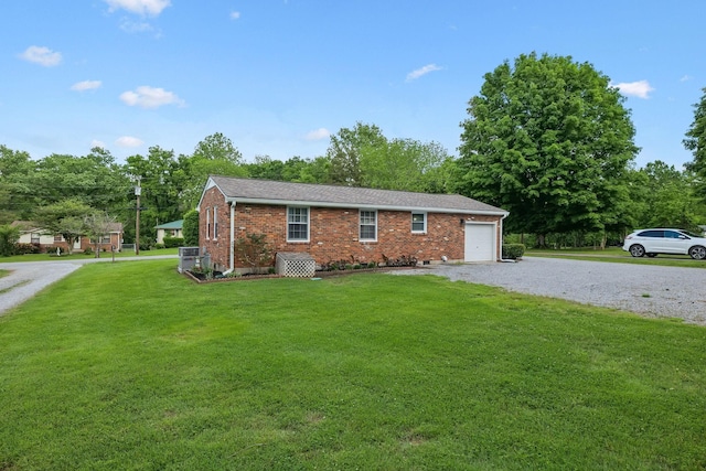 ranch-style home featuring a front lawn, brick siding, driveway, and an attached garage
