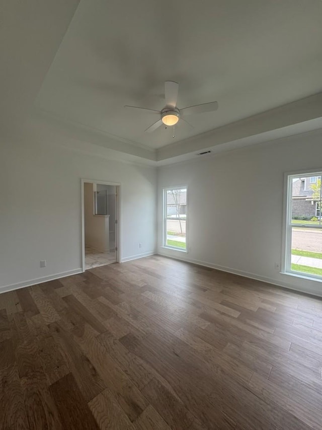 6709 Major Hutchings Dr, Hermitage, TN 37076 - empty room featuring a tray ceiling, wood finished floors, plenty of natural light, and a ceiling fan