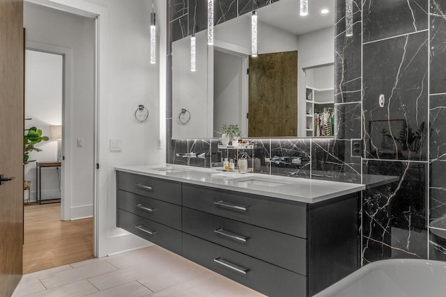 4303A Utah Ave, Nashville, TN 37209 - full bathroom featuring double vanity, decorative backsplash, and a freestanding bath