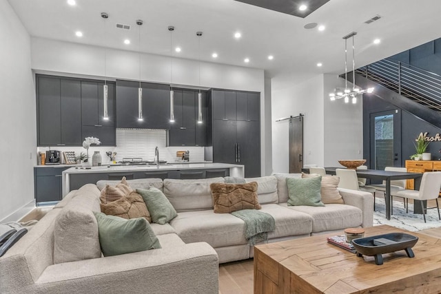 4303A Utah Ave, Nashville, TN 37209 - living room with a barn door, light wood finished floors, and recessed lighting