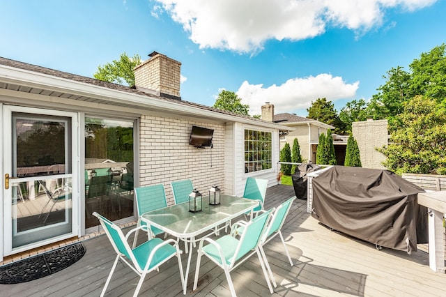 wooden terrace featuring outdoor dining space