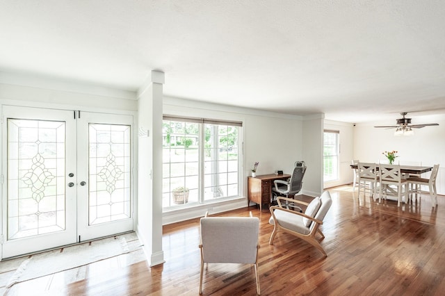 living room featuring wood finished floors, french doors, ceiling fan, and baseboards