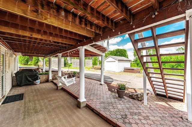 view of patio with an outdoor structure and a grill