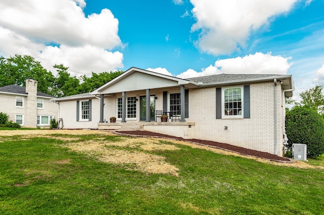 single story home with brick siding, a front lawn, and covered porch