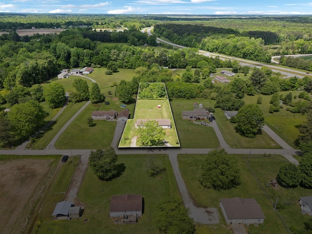 aerial view of property and surrounding area with property boundaries highlighted and a forest