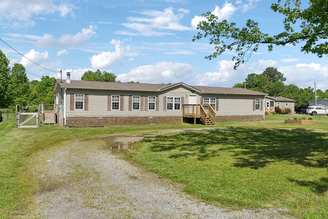 manufactured / mobile home with a gate, driveway, a front lawn, and crawl space