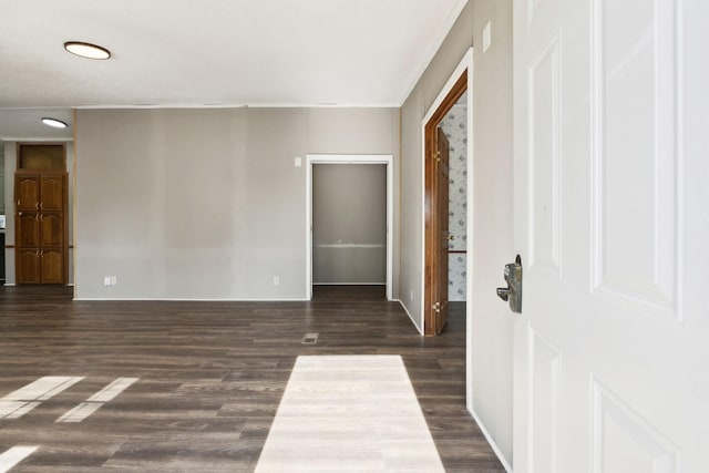 spare room featuring dark wood-type flooring, baseboards, and recessed lighting