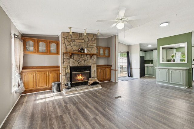 unfurnished living room with ornamental molding, a fireplace, ceiling fan, wood finished floors, and lofted ceiling