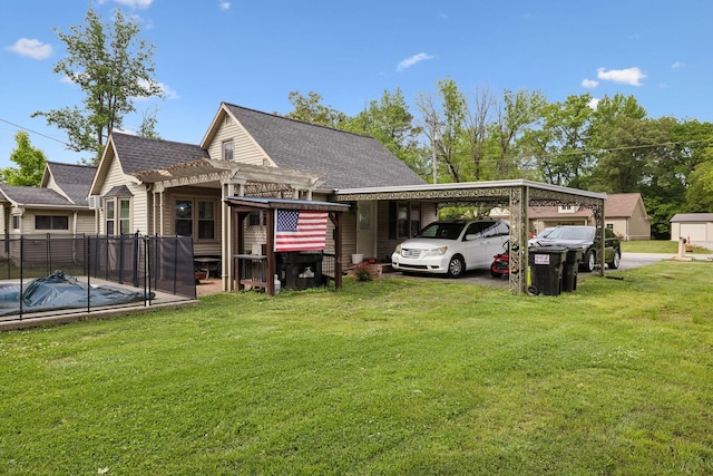 221 N Ewing St, Guthrie, KY 42234 - rear view of house with a carport, a pergola, roof with shingles, a lawn, and driveway