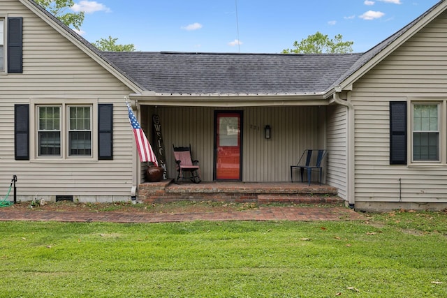 221 N Ewing St, Guthrie, KY 42234 - property entrance featuring covered porch, a lawn, and roof with shingles