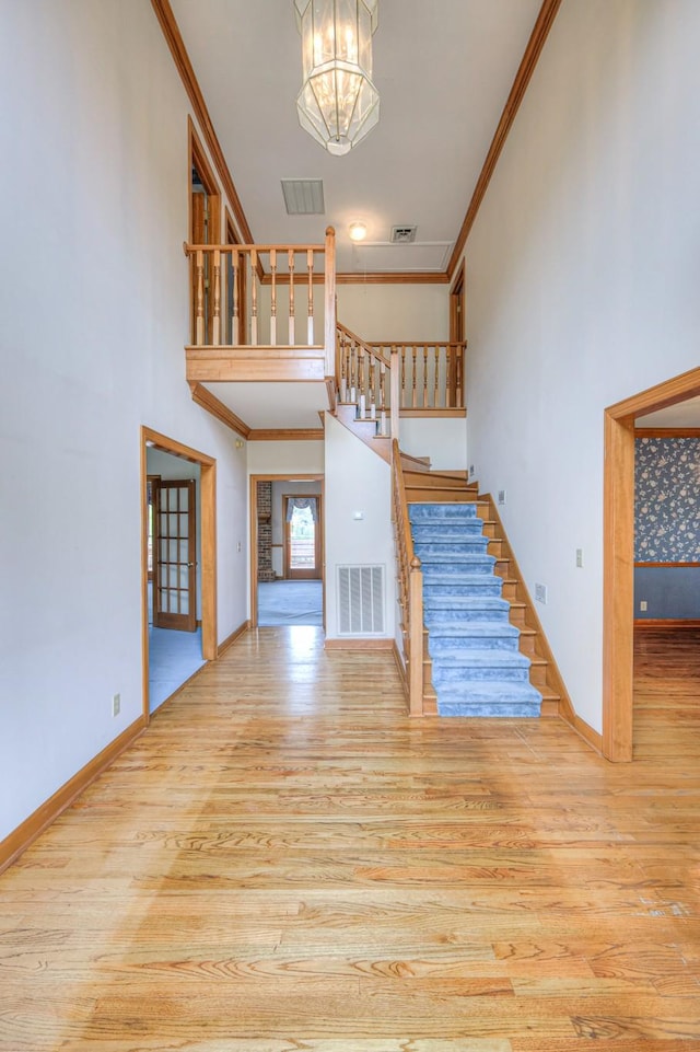 145 Dekewood Dr, Old Hickory, TN 37138 - unfurnished living room featuring stairway, wood finished floors, a chandelier, ornamental molding, and baseboards