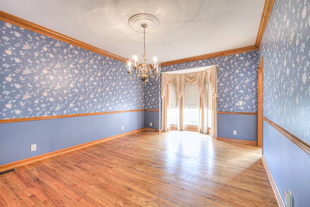 145 Dekewood Dr, Old Hickory, TN 37138 - unfurnished room featuring wallpapered walls, crown molding, a chandelier, wood finished floors, and baseboards